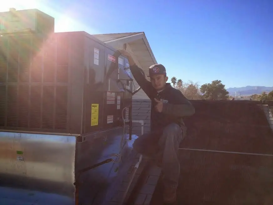 HVAC technician performing Boiler Repair on a rooftop unit in Silver Spring